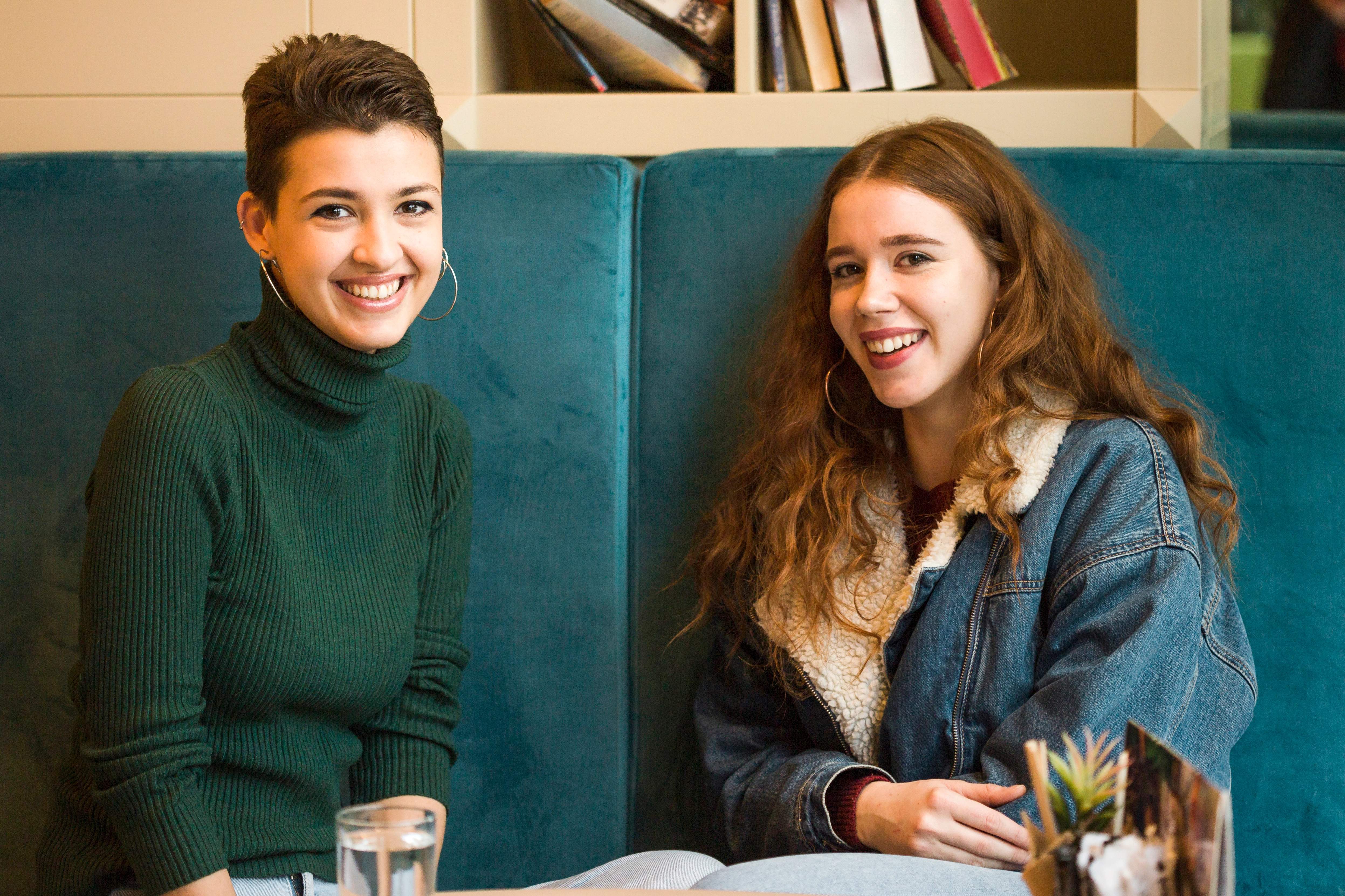 Two international students smiling together at an MCG Career College campus
